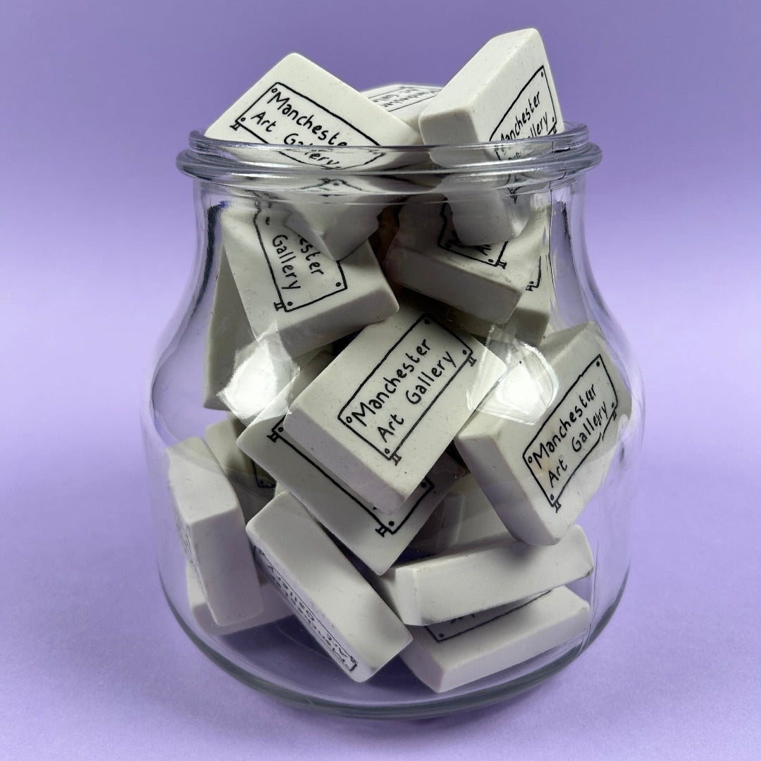 A clear glass jar full of erasers