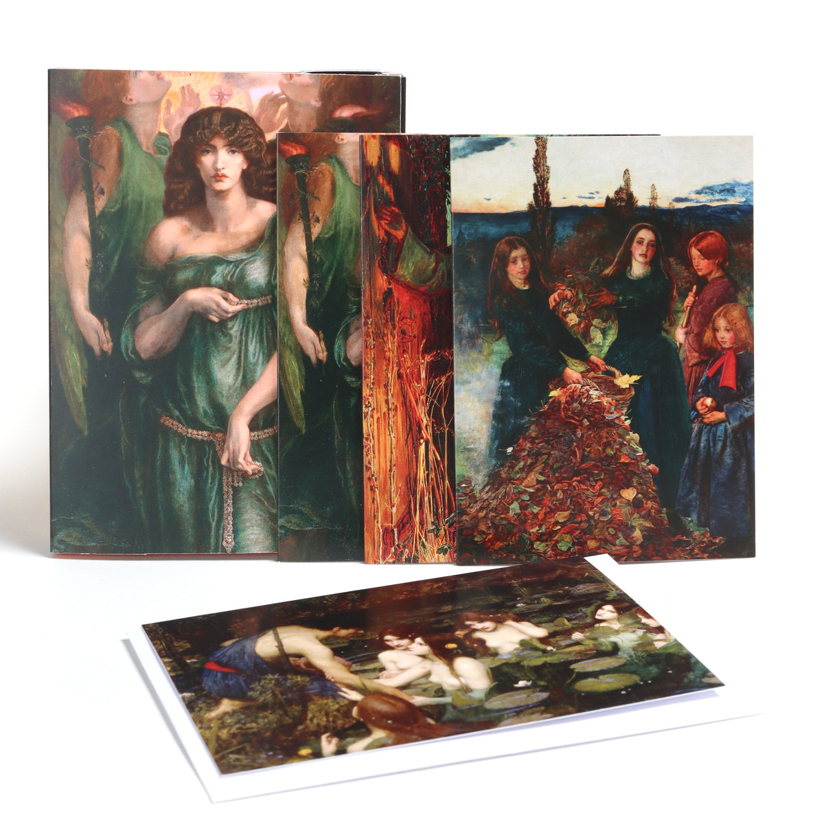Pack of greetings cards photographed on a white background. The cards feature artworks by the Pre-Raphaelite Brotherhood. Including Autumn Leaves by John William Waterhouse, Astarte Syriaca by Dante Gabriel Rossetti and Hylas and the Nymphs by John William Waterhouse.