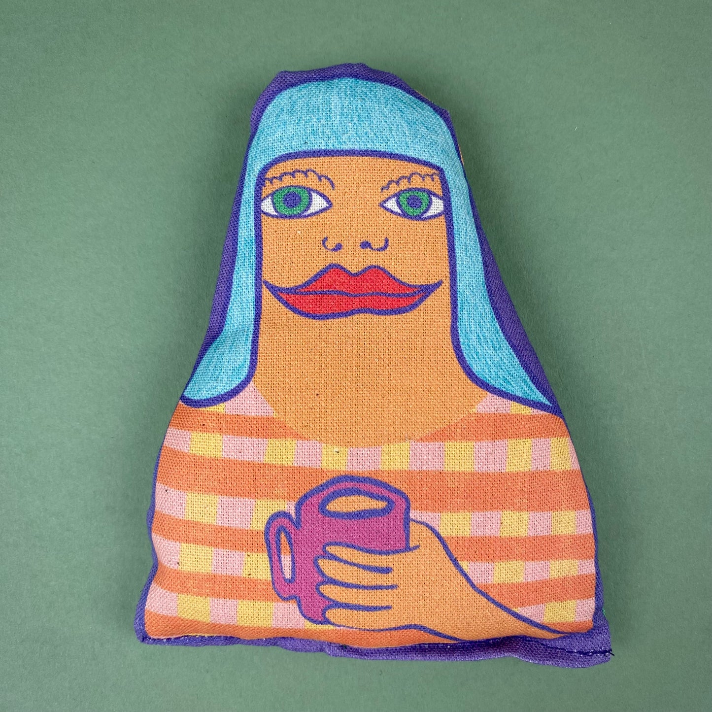 fabric lavender bags with illustrated faces of a woman with long hair holding a mug