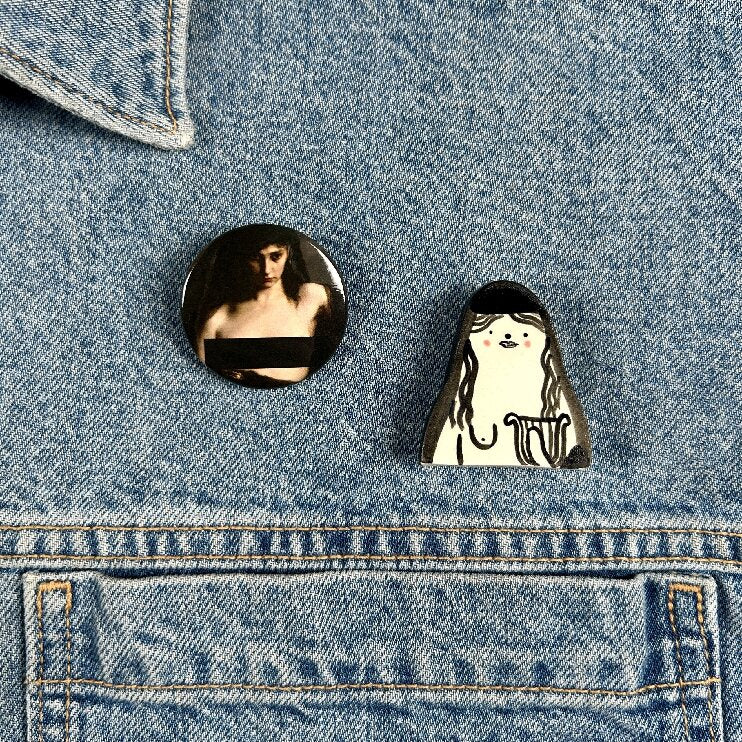 Sappho Censored badge and ceramic pin on a jacket